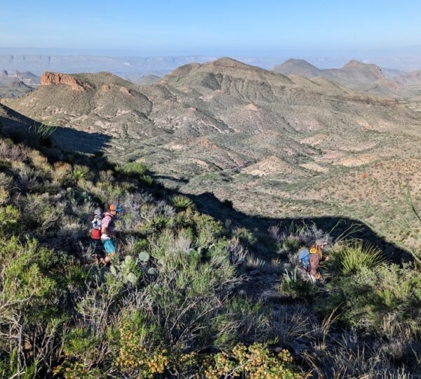 Hiking out by Mule Ears